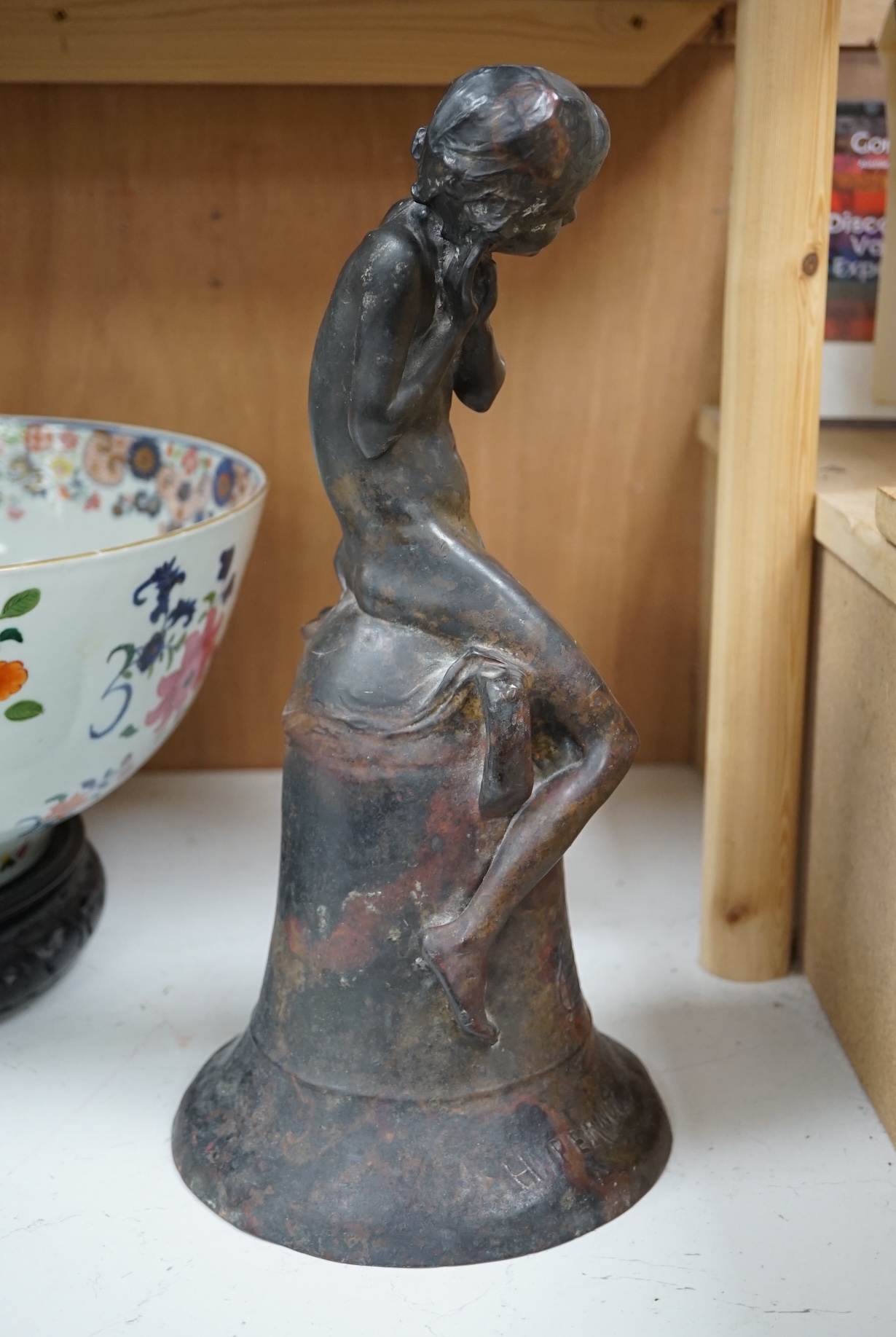 After Henri Pernot (1859-1937), a bronze figure of a boy seated on a bell, signed, 38cm high. Condition - fair to good